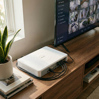 Hikvision DS-7108NI-Q1/8P NVR on a media console with cables plugged into rear ports